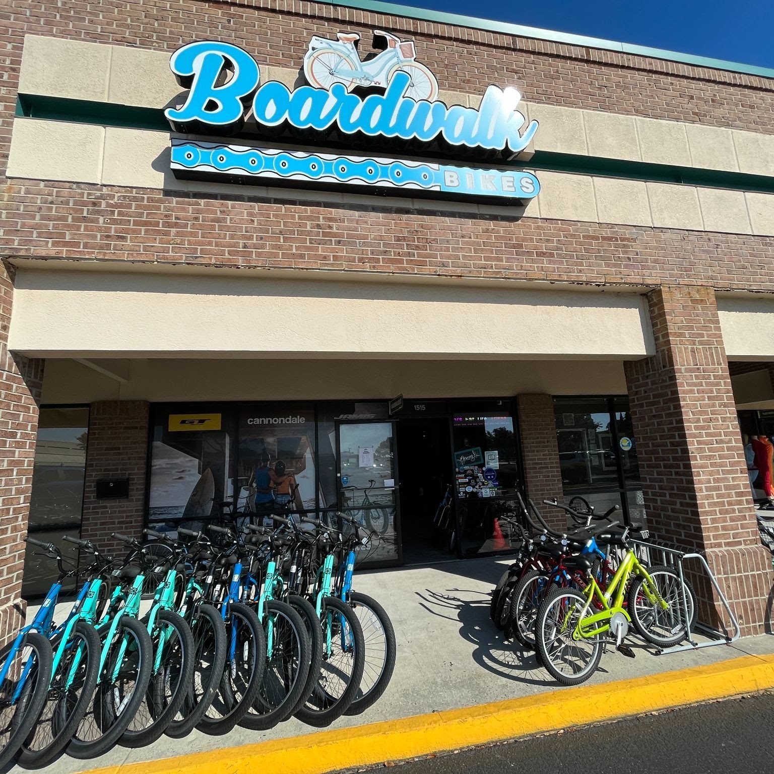 The Boardwalk Bikes storefront in Kings Festival Shopping Center with rental bikes lined up outside